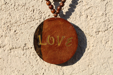 Wooden Medallion and wooden bead Necklace.  Gold Dust Highlighting the LOVE that exist in this world and in your Life. 
